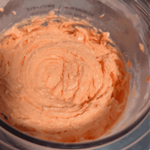 Orange Creamsicle Ninja Creami Ice Cream in a blender container.