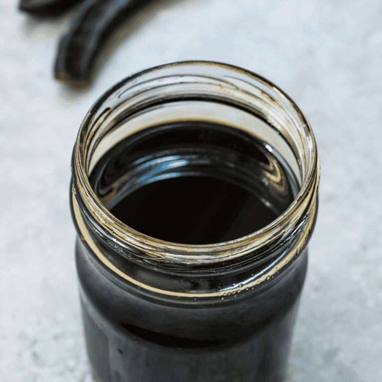 Black coffee in a glass jar, perfect for breakfast or a morning boost.