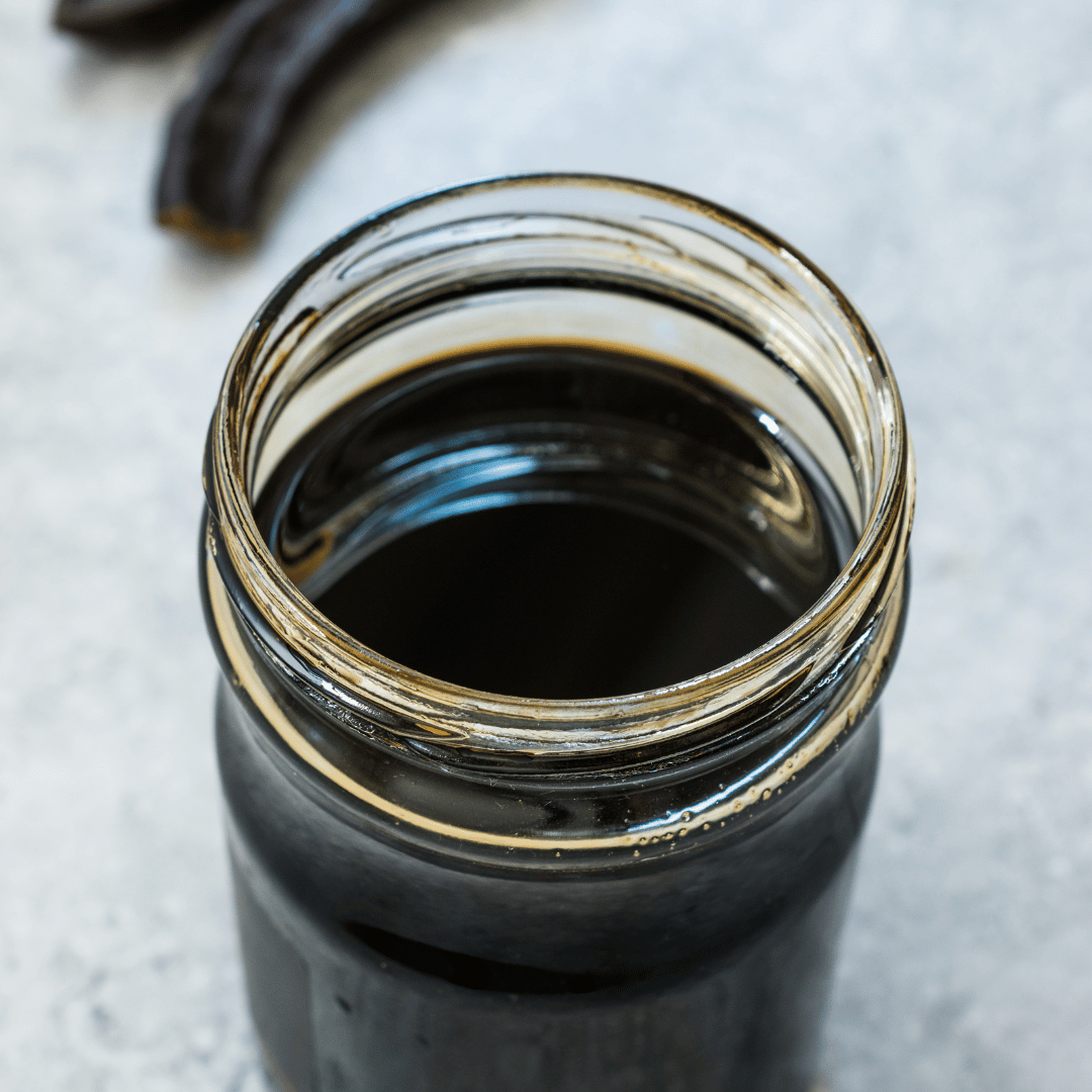 Black coffee in a glass jar, perfect for breakfast or a morning boost.