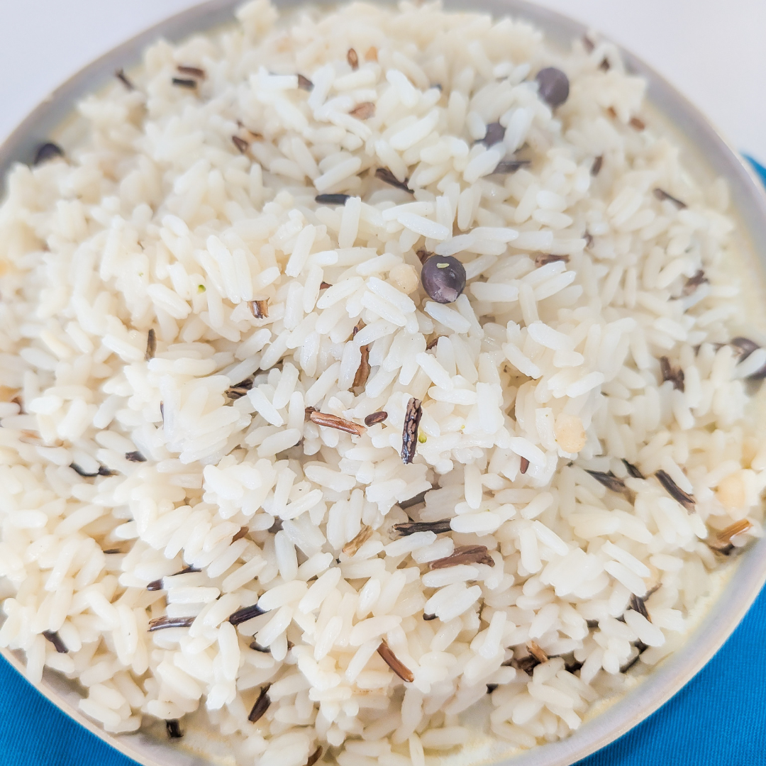 Fragrant steamed rice with herbs and spices, close-up view.