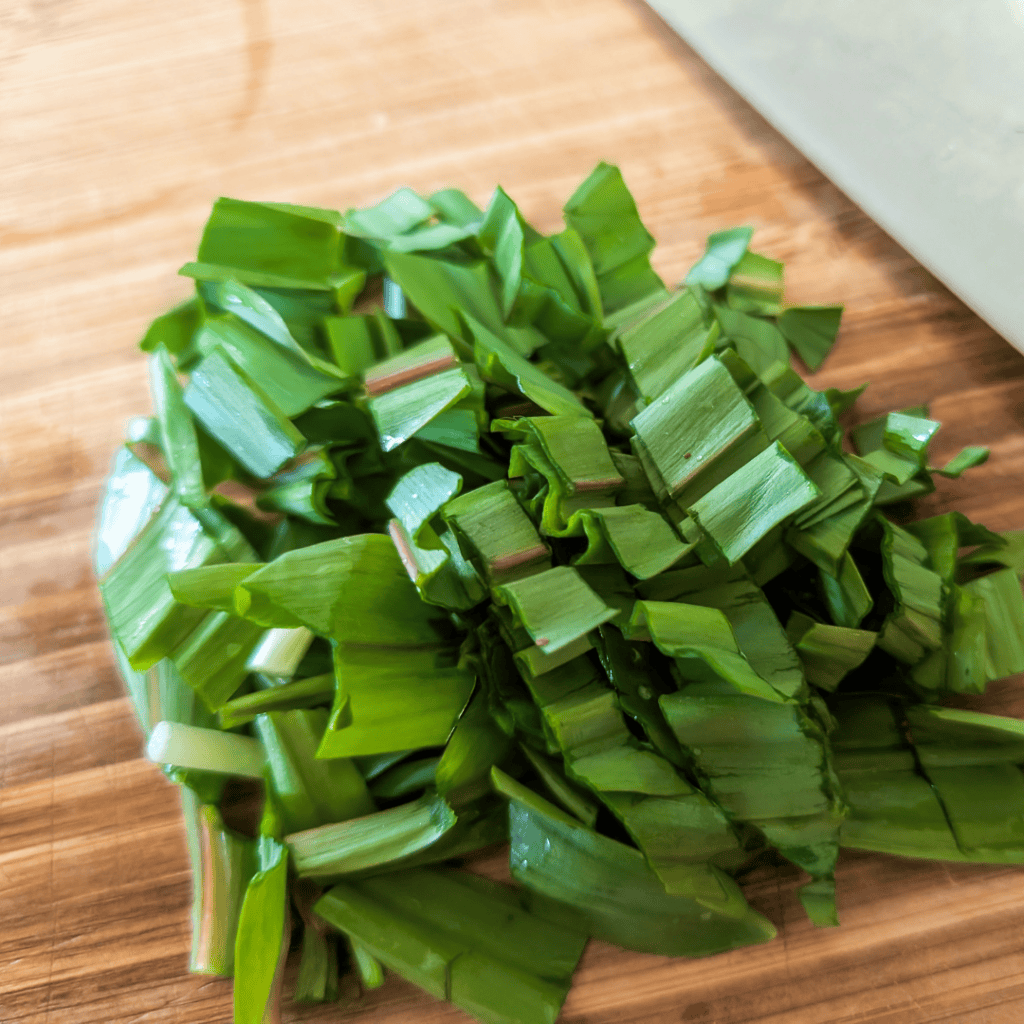 Chopped ramps, a flavorful wild onion, ready to add to mushroom rice pilaf with peas.