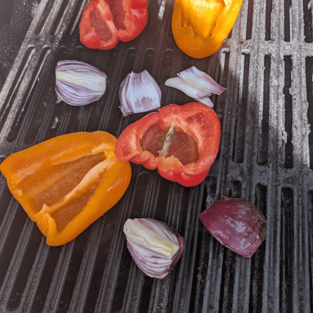 Bright bell peppers and garlic cloves ready for grilling or cooking.