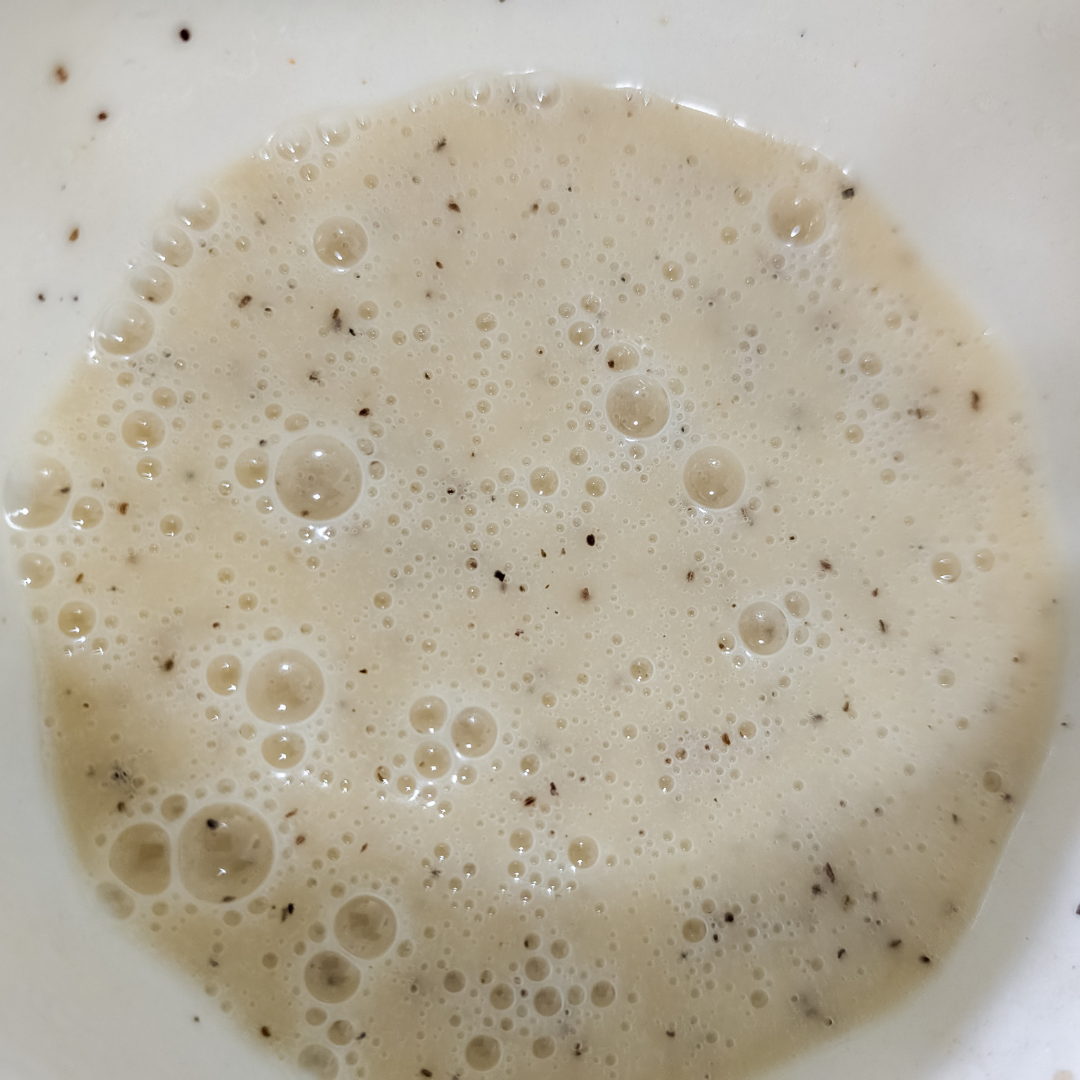 Batter mixture with black specks, ready for cooking or baking.