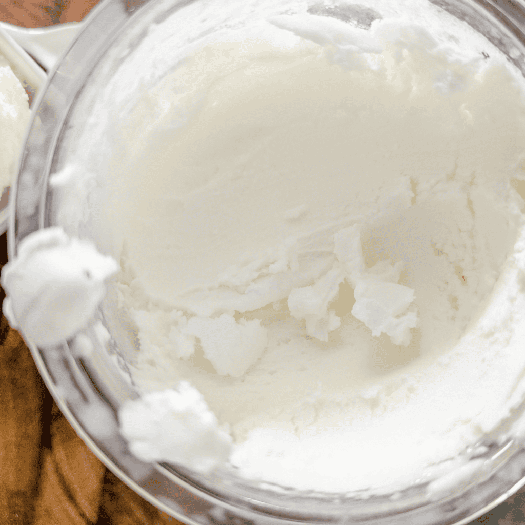 Creamy vanilla ice cream in a metal bowl, perfect for dessert or snacking.