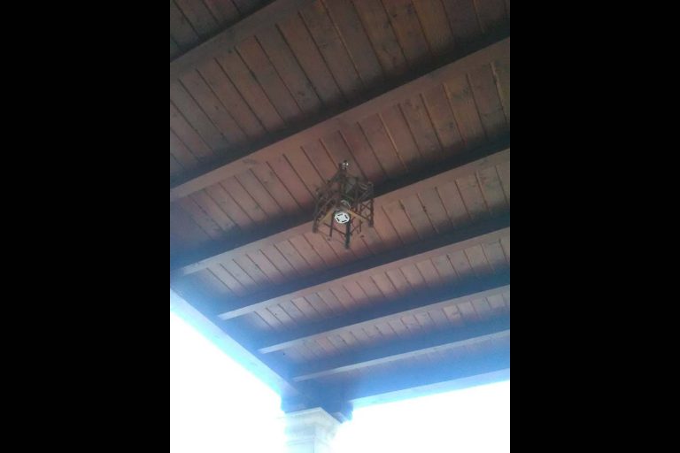 Puente de madera con luminaria de reparación en un espacio cubierto.