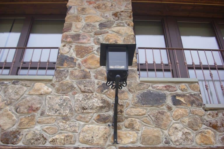 Candado de seguridad en puerta de piedra en fachada residencial de cerrajería Osfran.