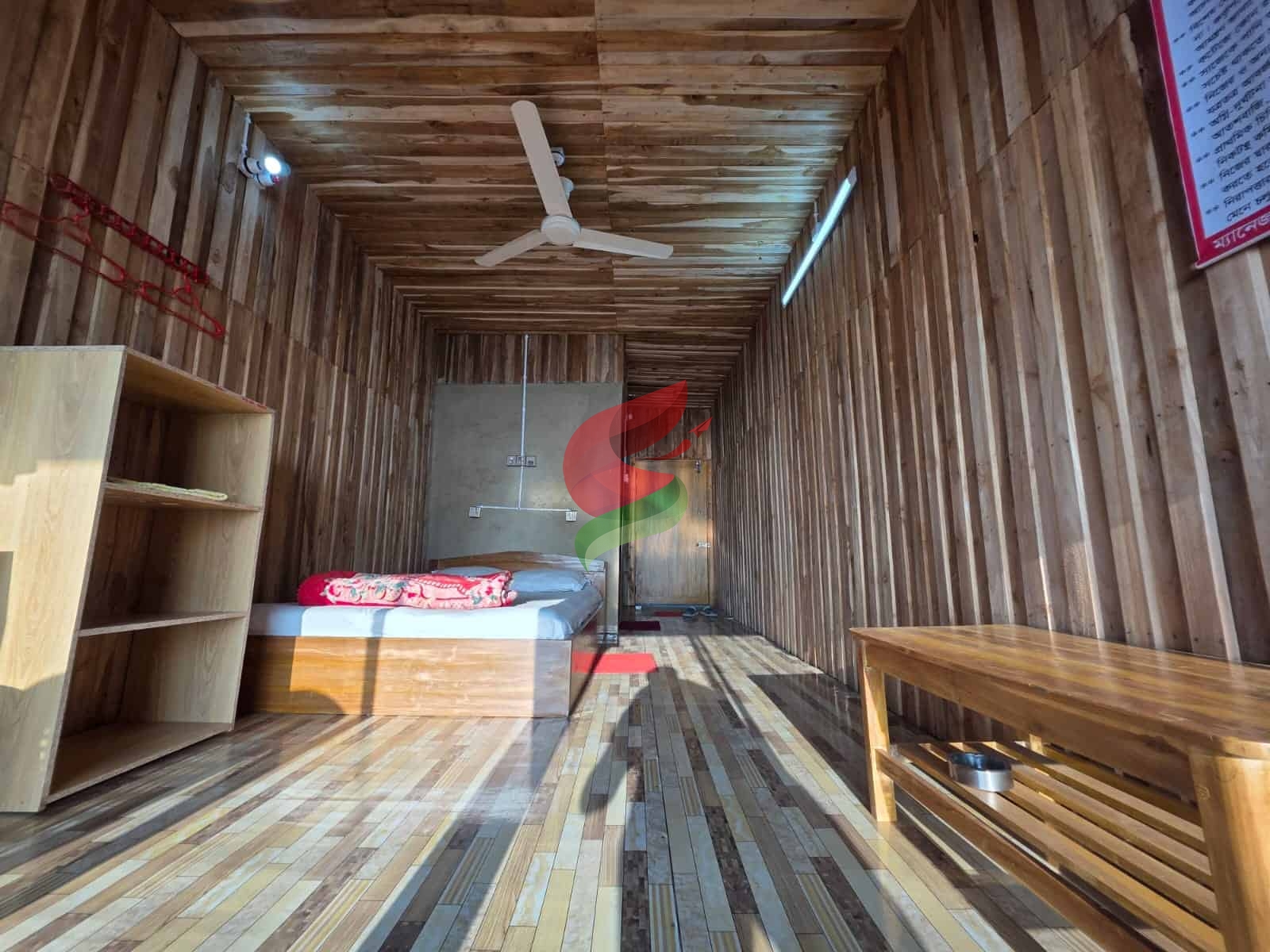 Stunning wooden room B1 at Check In Cherish, featuring a cozy bed, ceiling fan, and minimalist decor for relaxation.