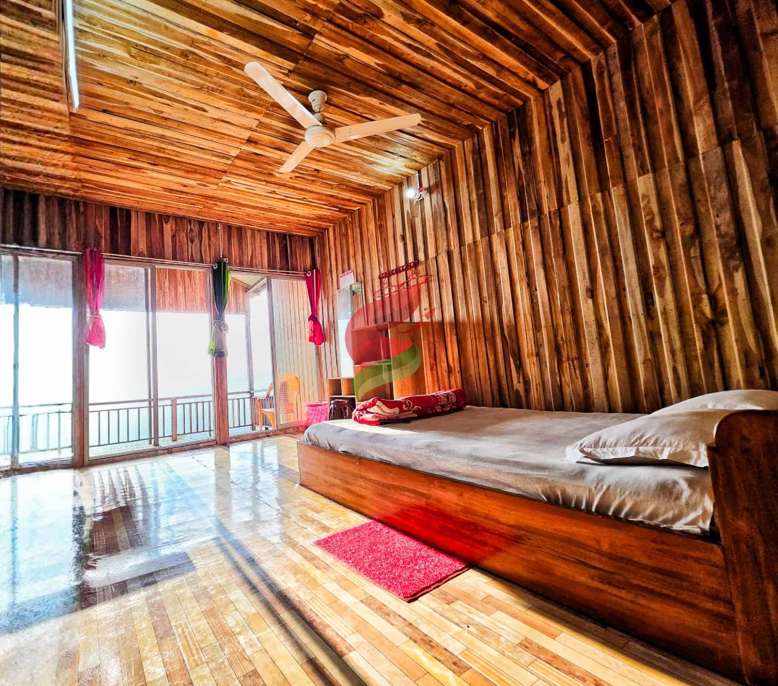 Bright room featuring wooden interior, balcony access, and relaxing atmosphere for guests.