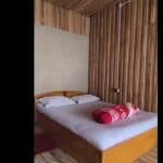 Cozy wooden bedroom with minimalist design, perfect for relaxation at Check In Cherish.