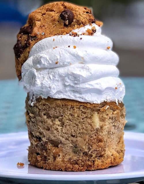 Cookie dough cheesecake with chocolate chips and whipped cream topping.