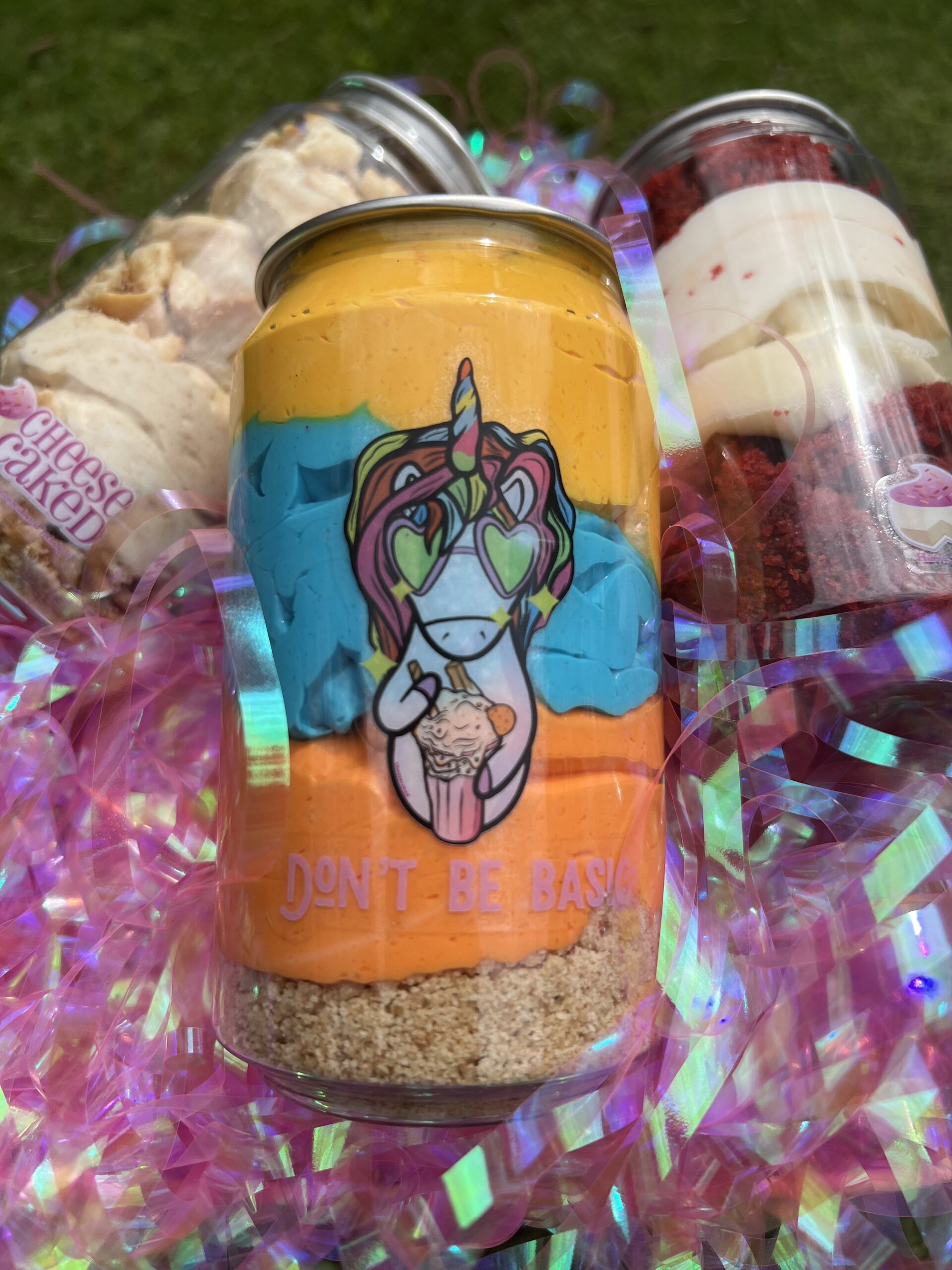 Unicorn-themed cheese cake jars with colorful designs, perfect for dessert lovers.