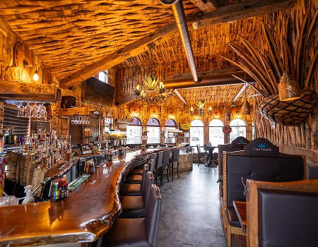 Interior view of the bar area with wooden decor and seating at Casa Tequila Mexican Grill & Cantina.
