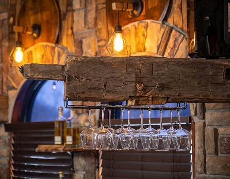 Cozy bar area with hanging glasses and warm lighting at Casa Tequila Mexican Grill & Cantina in Chic.