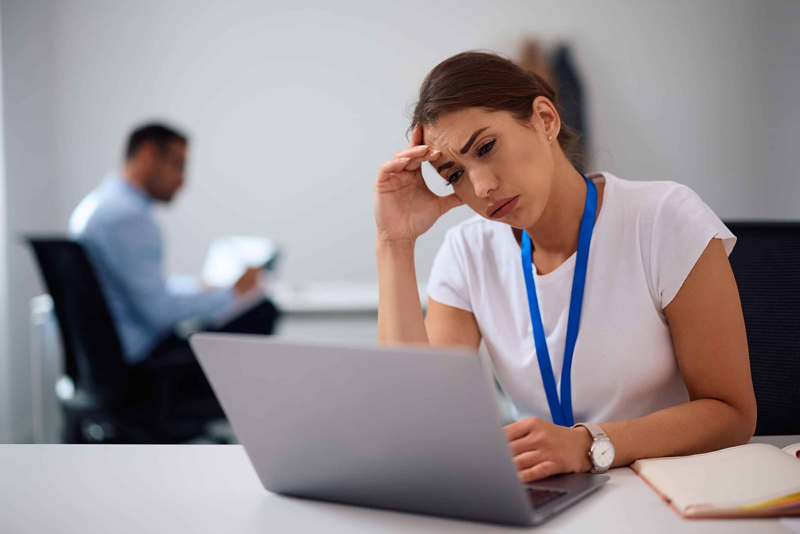 Worried Businesswoman Working On Laptop In The Office.