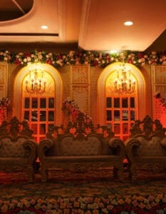 Elegant wedding stage with floral decor and ornate furniture at Classic Caterers, Phagwara.