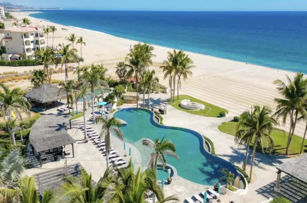 Infinity Pool With Beachfront Access And Palm Trees At A Luxury Resort Near Club Campestre Real Estate In Los Cabos.