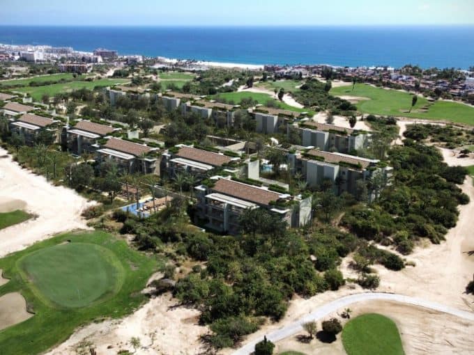 Aerial View Of Luxury Condos Surrounded By Golf Course Greens And Ocean Views In Club Campestre Real Estate, San José Del Cabo.