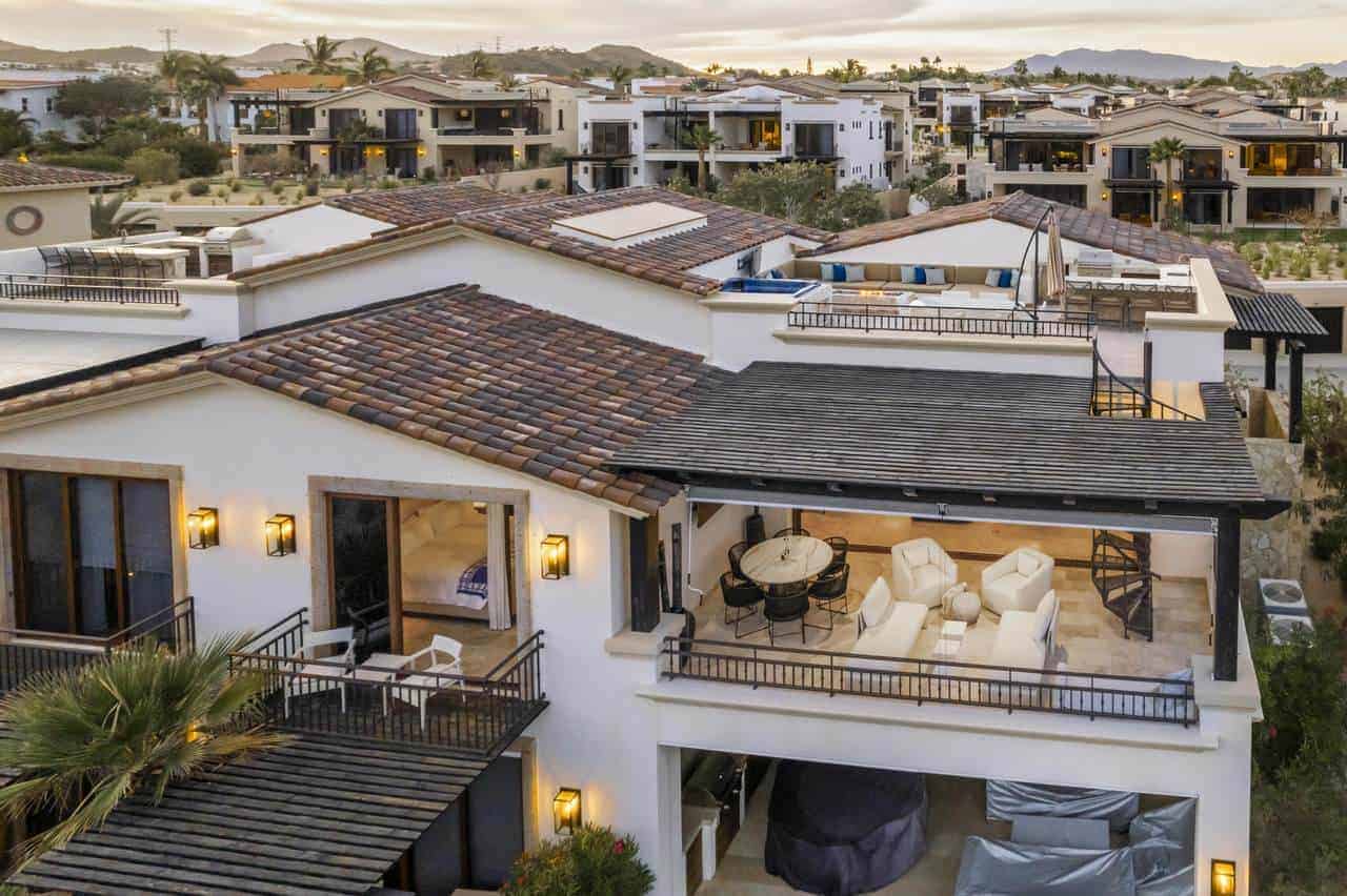 Luxury villa with ocean views and a spacious rooftop patio, perfect for enjoying golf course scenery and sunset vistas. Elegant outdoor seating area ideal for relaxing and entertaining.