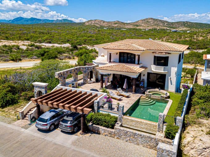 Guide To Buying In Club Campestre San JosΓ© Del Cabo (2025 Edition) β Homes For Sale In Club Campestre Luxurious House With Pool, Golf Course, And Ocean View At Club Campestre, Featuring Spanish-Style Architecture, Lush Greenery, And Scenic Mountain Background. Perfect For Golf And Seaside Living Enthusiasts.