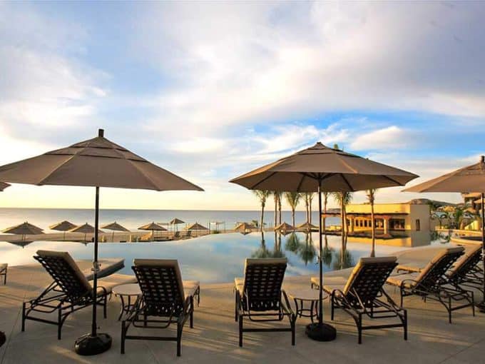 Golf Course With Ocean View At Club Campestre, Luxurious Resort Amenities, Beautiful Scenery, Relaxing Poolside Lounge Chairs Under Umbrellas, Perfect For Golf And Ocean View Living.