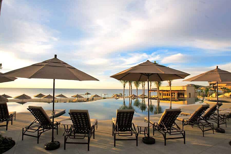 Golf Course With Ocean View At Club Campestre, Luxurious Resort Amenities, Beautiful Scenery, Relaxing Poolside Lounge Chairs Under Umbrellas, Perfect For Golf And Ocean View Living.