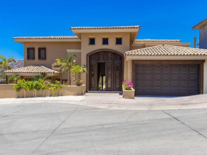 Luxurious House Front View At Club Campestre With Ocean And Golf Course Scenery In The Background.