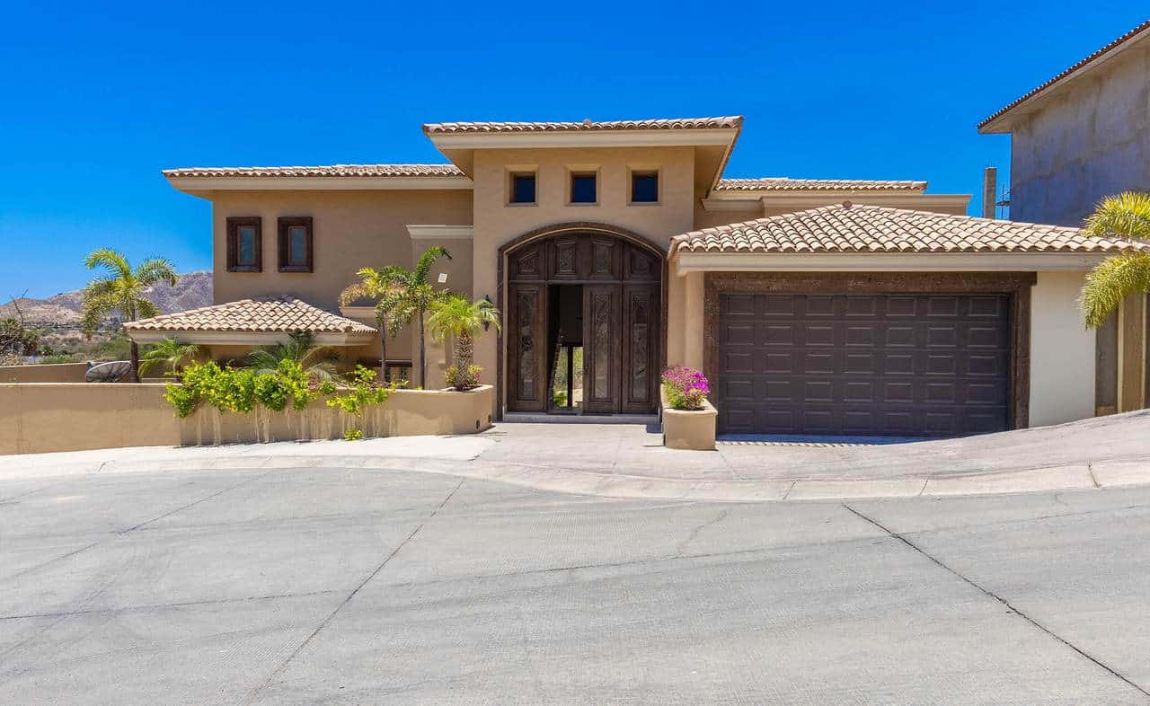 Luxurious House Front View At Club Campestre With Ocean And Golf Course Scenery In The Background.