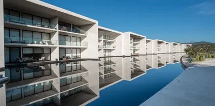 Luxury condos in Club Campestre with ocean view and nearby golf course, modern architecture with balconies and poolside amenities, perfect for golf lovers and ocean enthusiasts.