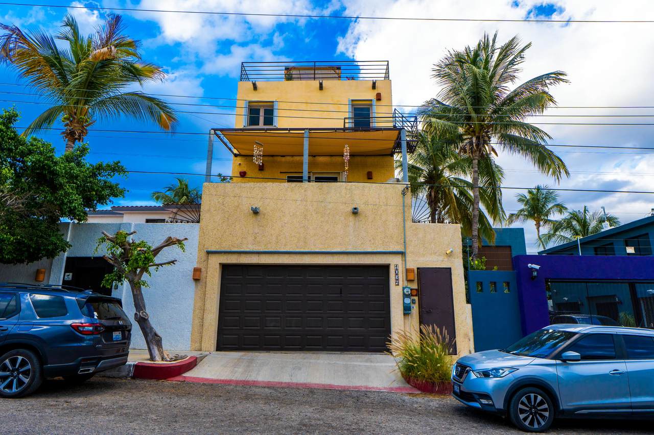 Luxurious Yellow House With Ocean Views, Surrounded By Tropical Palm Trees And Overlooking Golf Course, Available For Premium Real Estate At Club Campestre; Perfect For Embracing Coastal Living.
