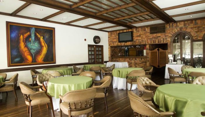 Club Campestre-Dining Elegant Interior Of A Restaurant At Club Campestre Featuring A Cozy Ambiance, With Wooden Accents, Comfortable Chairs, And Vibrant Artwork, Perfect For Relaxing After A Golf Game Or Enjoying Ocean Views.