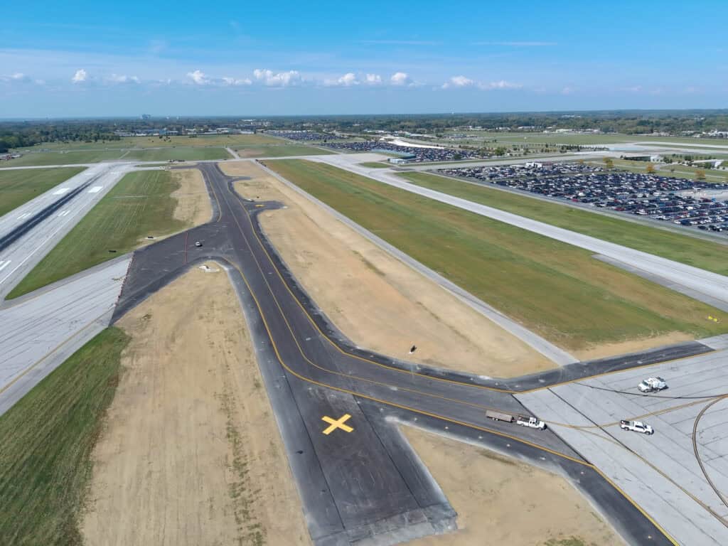 Aerial view of taxiway C on the south airfield at John Glenn Columbus International Airport. Newer sections of the taxiway are visible from darker cement.