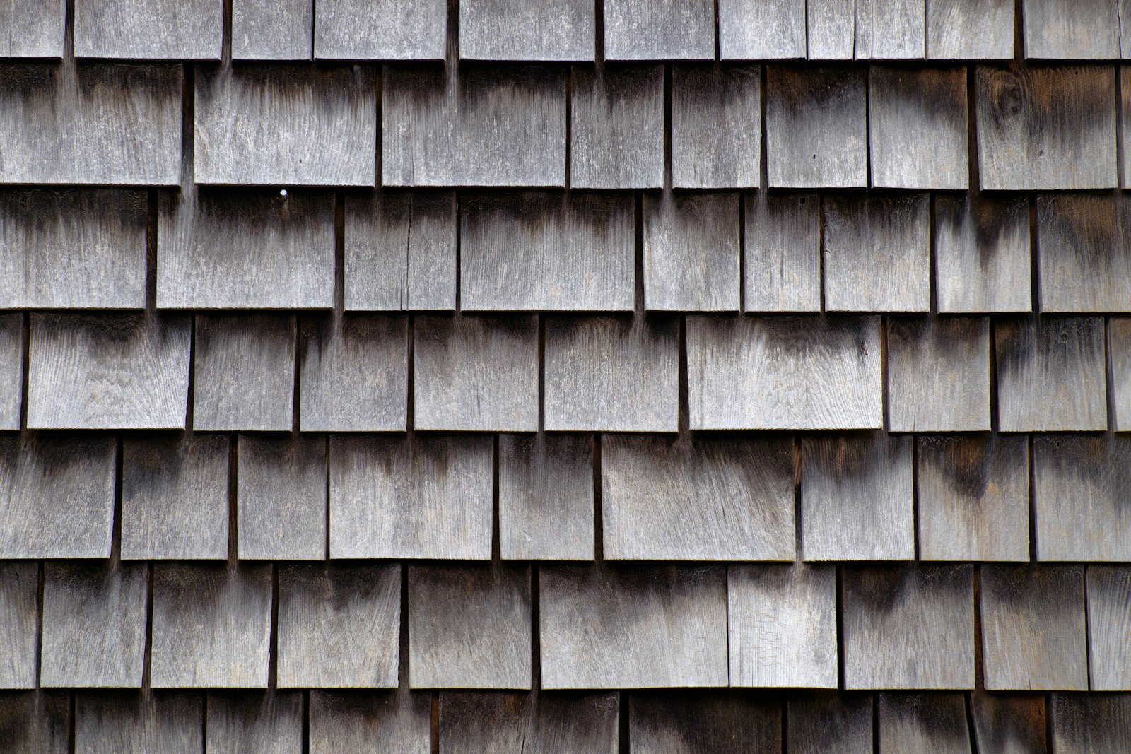 Cedar shingle siding weathering on a Cape Cod coastal home near Barnstable, MA