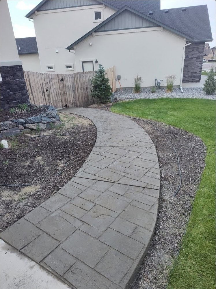 Front entry concrete walkway Colorado Springs - curved pathway with decorative borders