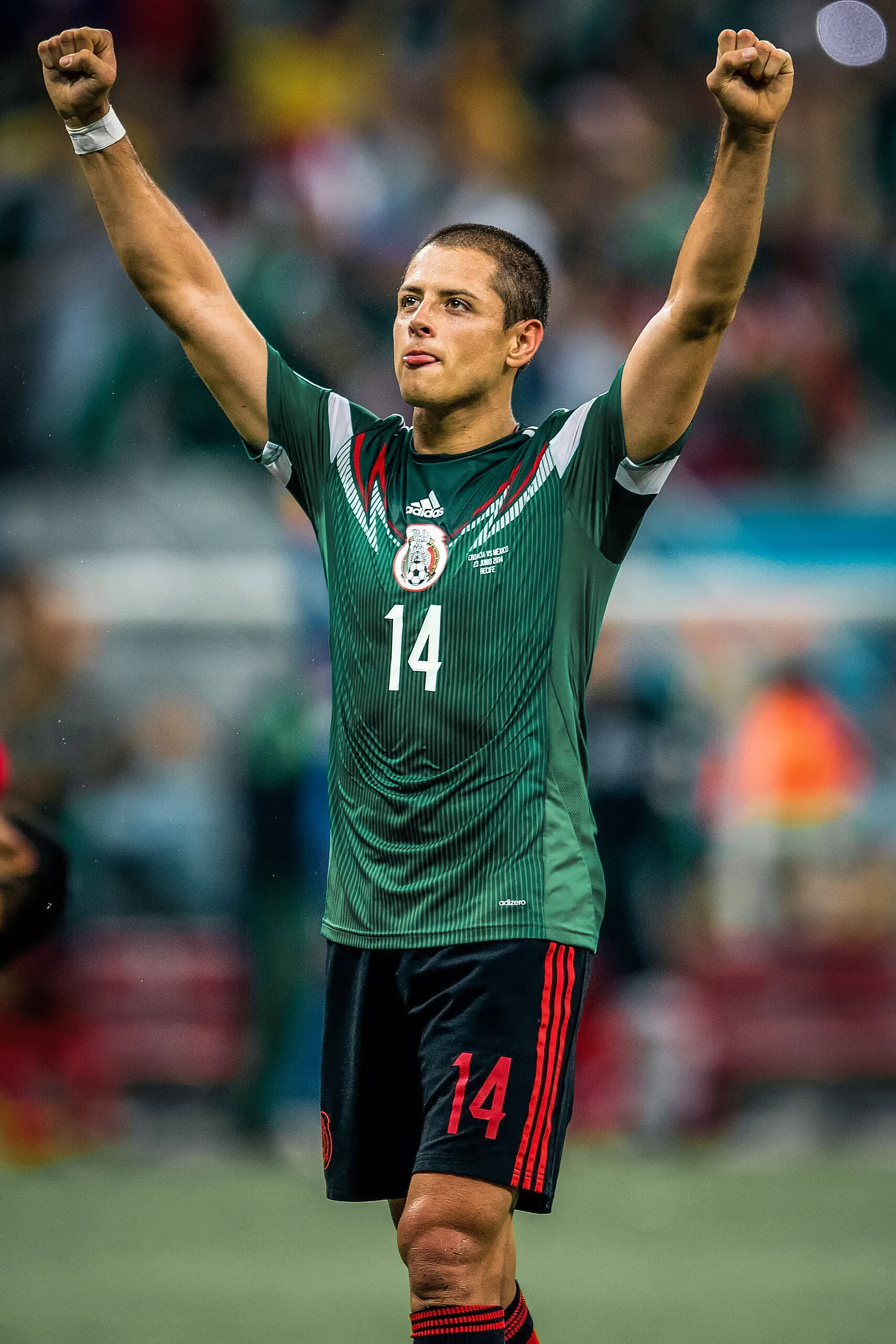 Futbolista mexicano celebrando con brazos en alto, apoyo en su carrera deportiva, selección de fútbol México, deporte y pasión.