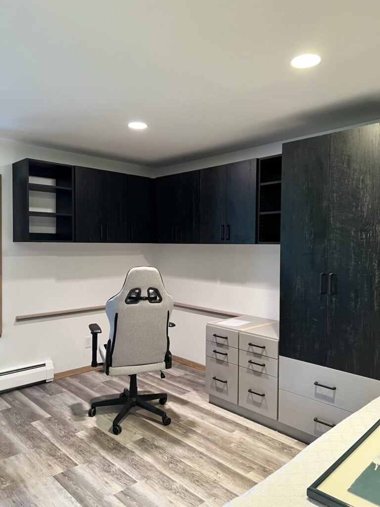 Modern home office with custom dark wood cabinets and storage solutions.