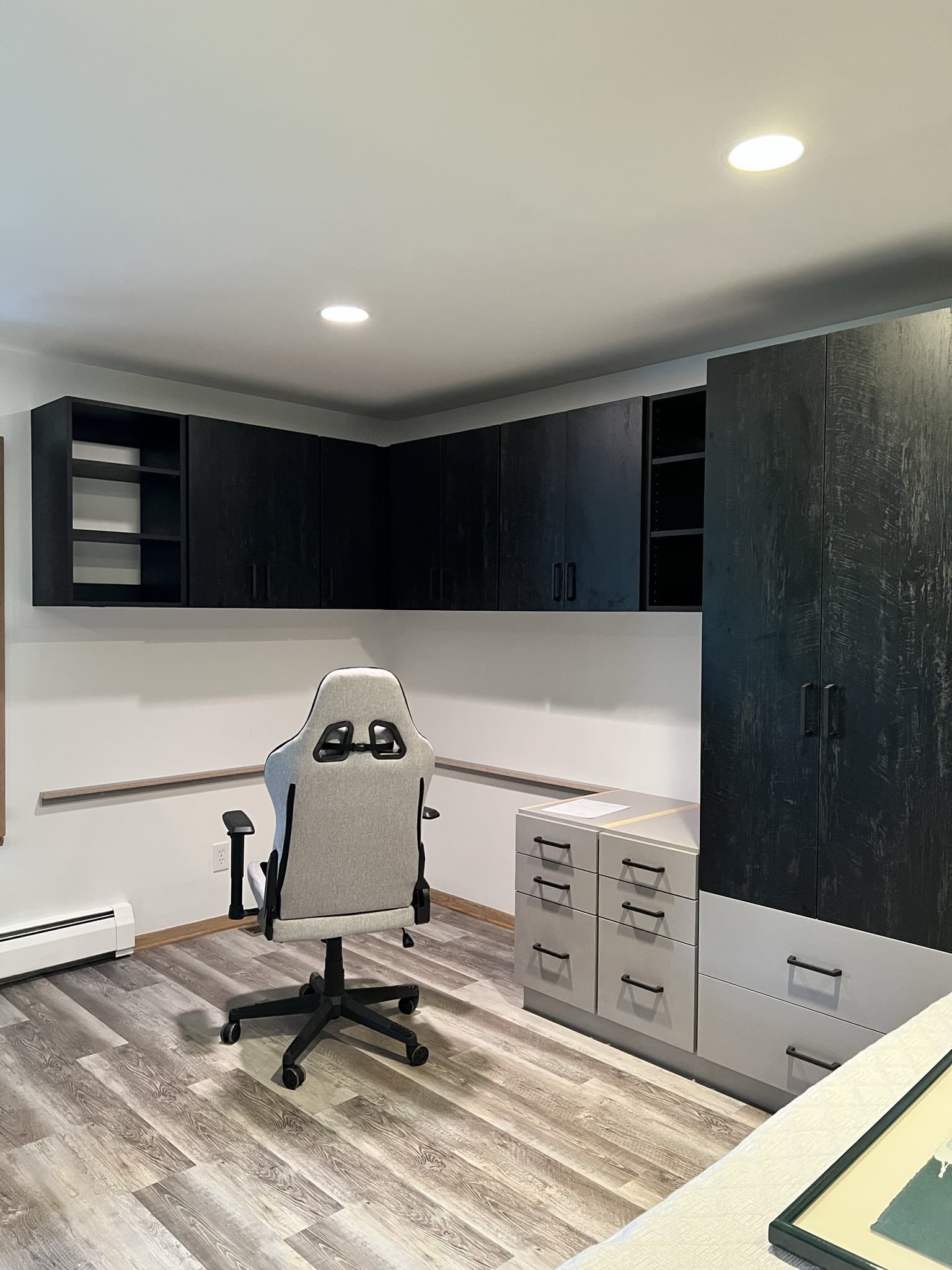 Modern home office with custom dark wood cabinets and storage solutions.