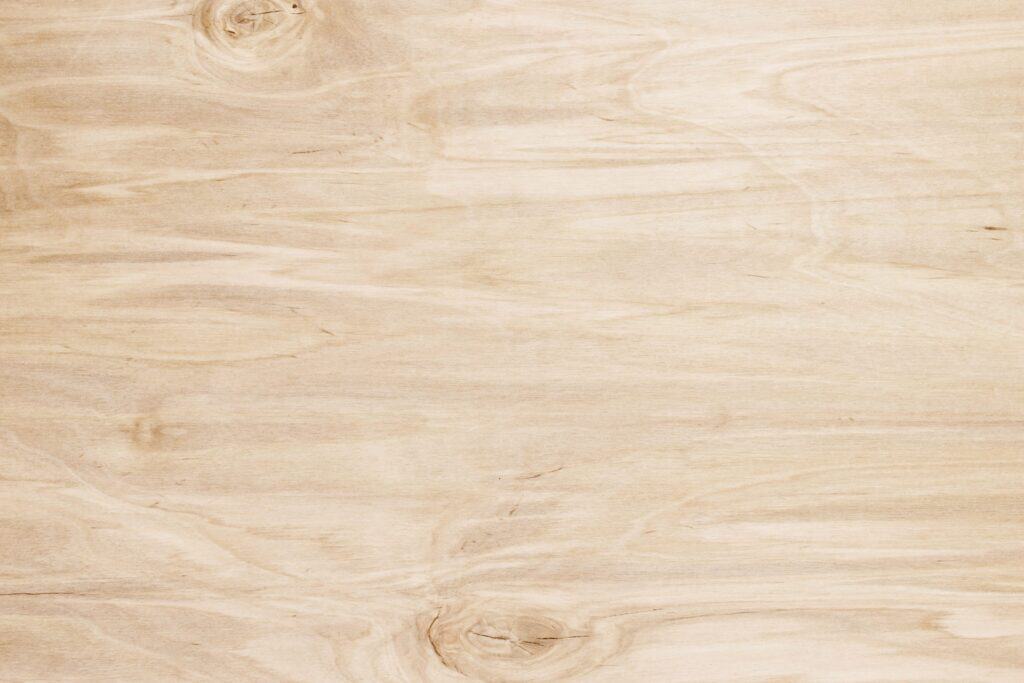 Light natural wood surface for custom closet and storage solutions.