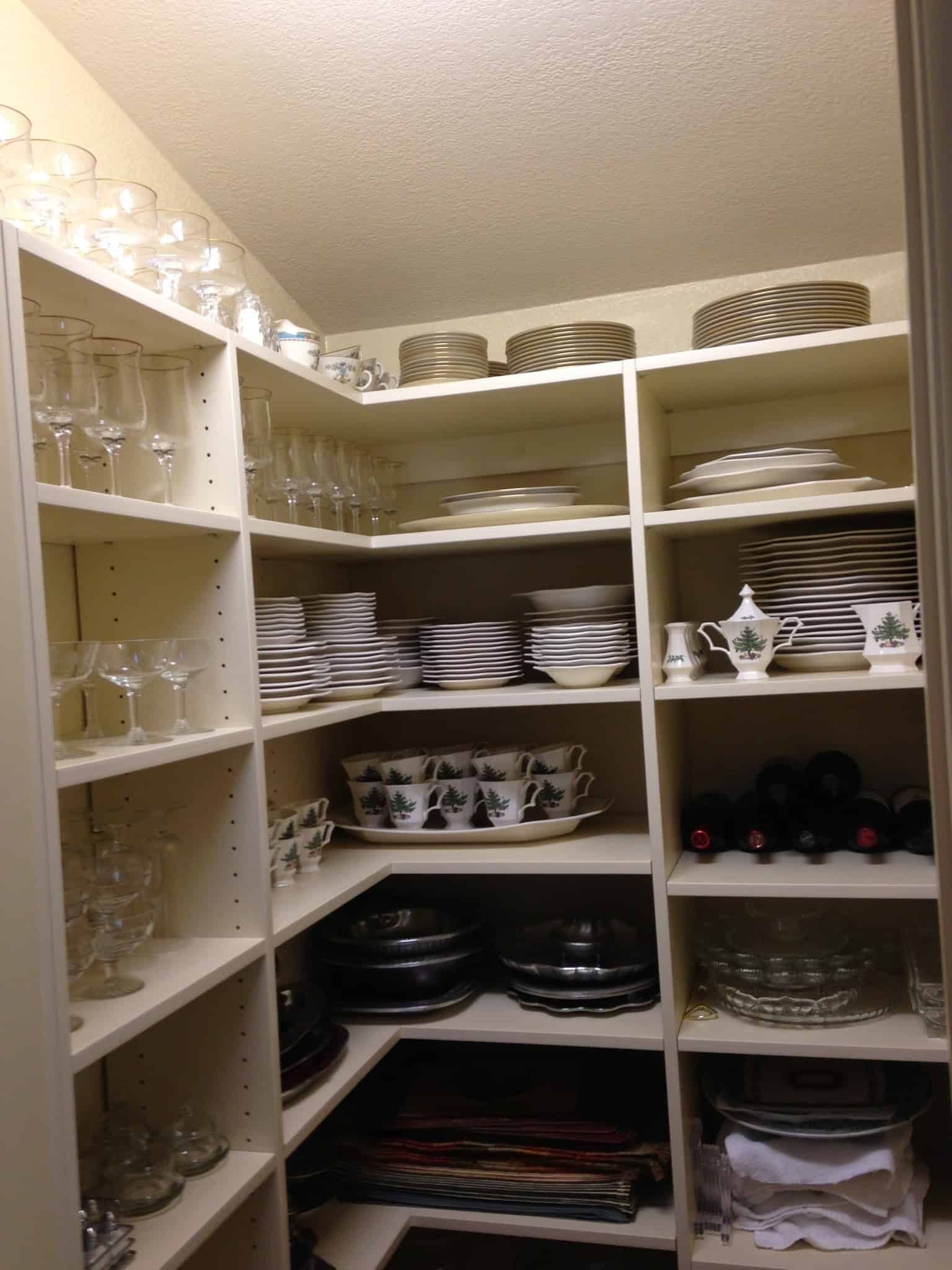 Organized custom closet with plates, glasses, and storage shelves in Durango.