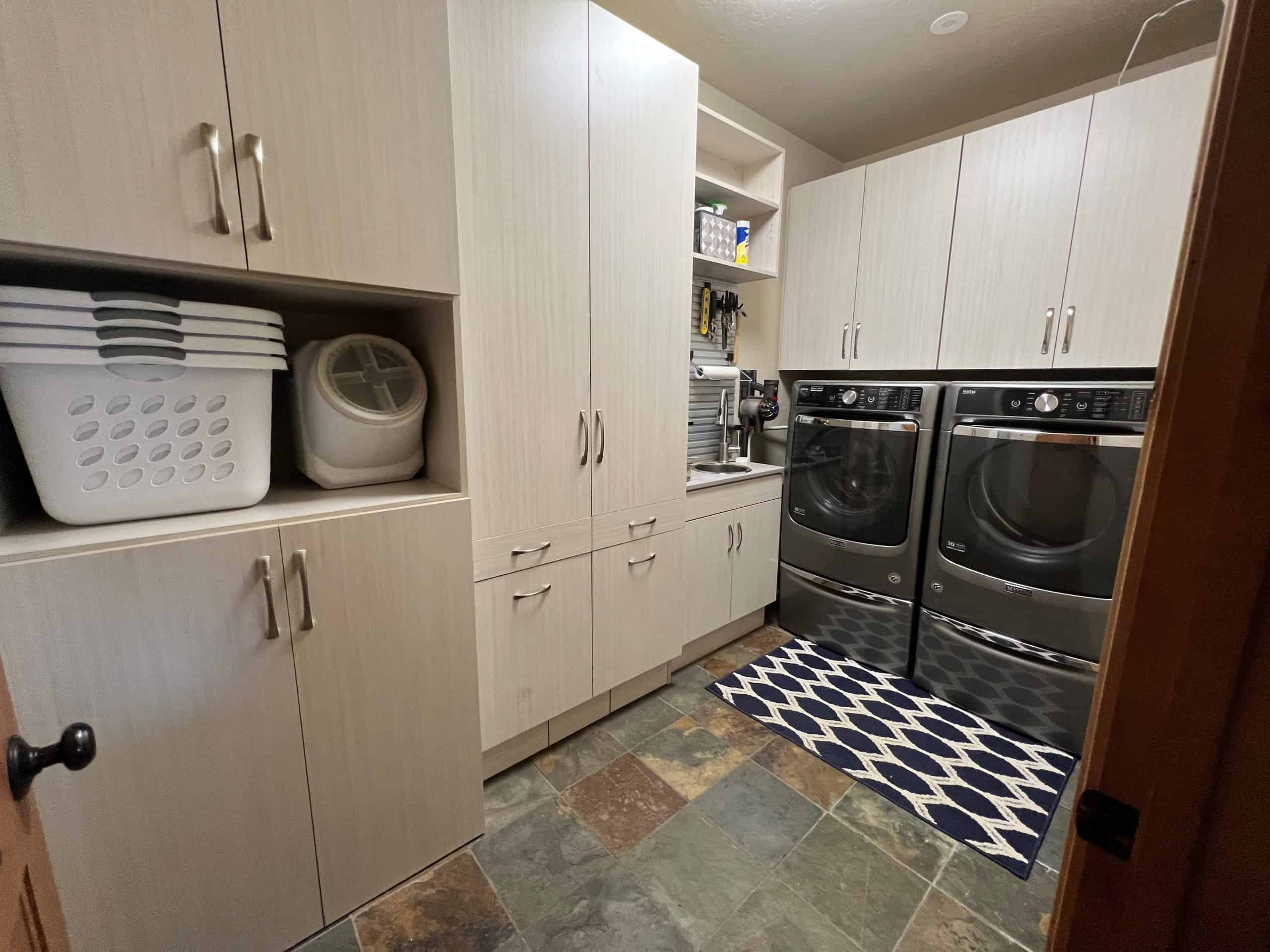 Organized laundry room with cabinets, washer, and dryer in Durango, Colorado.