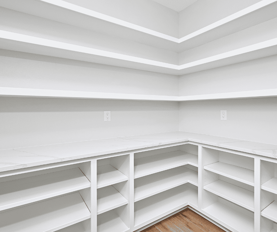 Custom white closet storage with multiple shelves and cabinets in Durango.