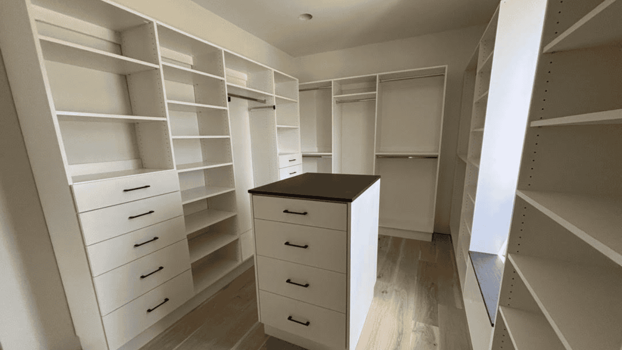 Custom white closet with drawers and shelves in Durango home.