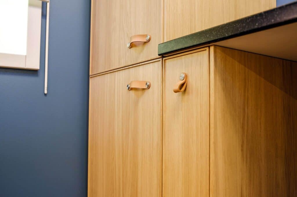 Close-up of custom wooden kitchen cabinets with sleek handles in Durango.