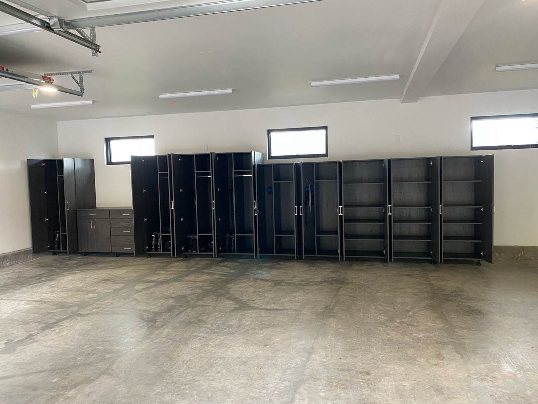 Custom storage cabinets and lockers in a spacious garage or storage room.