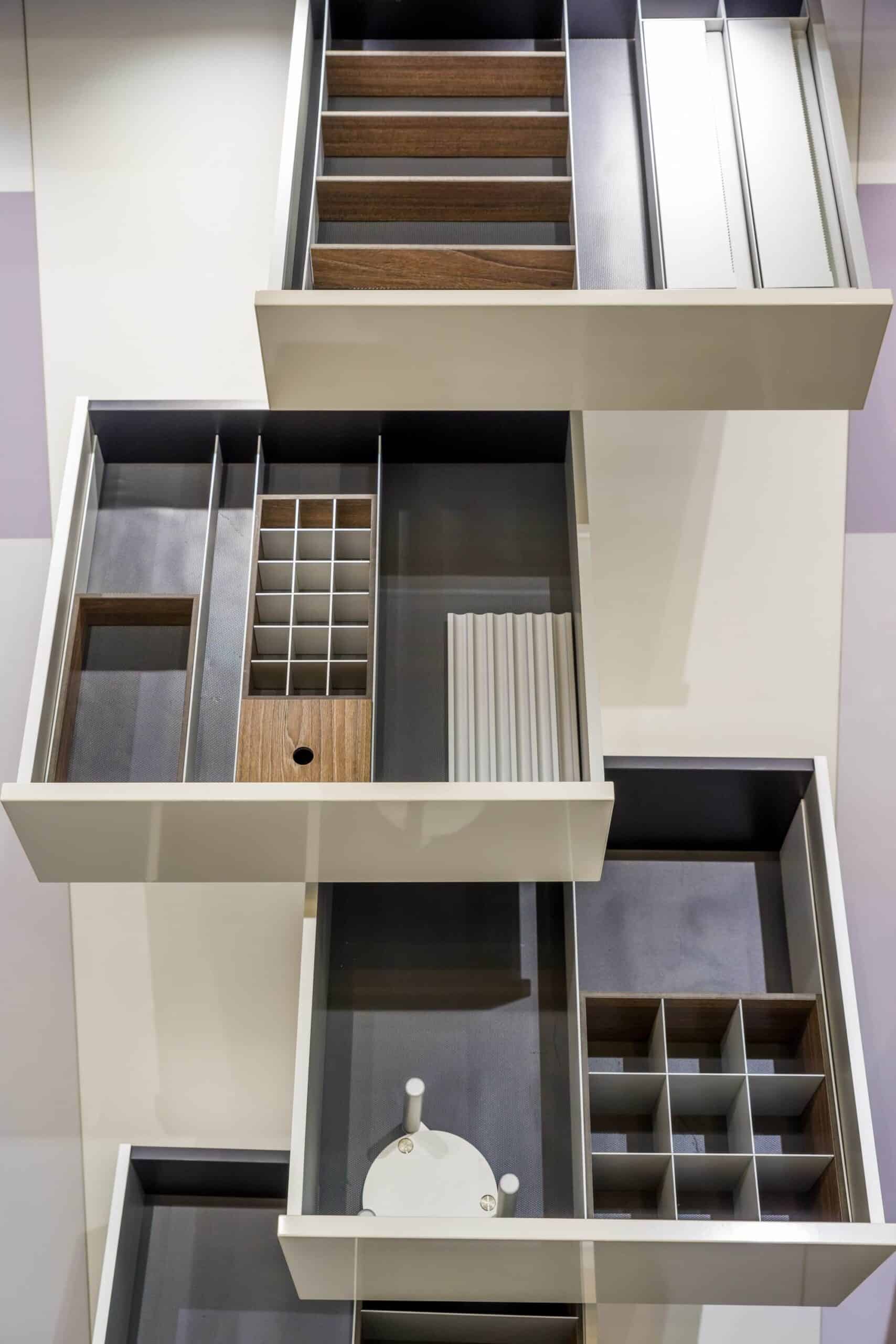 Modern custom closet with drawers, shelves, and compartments for organization.