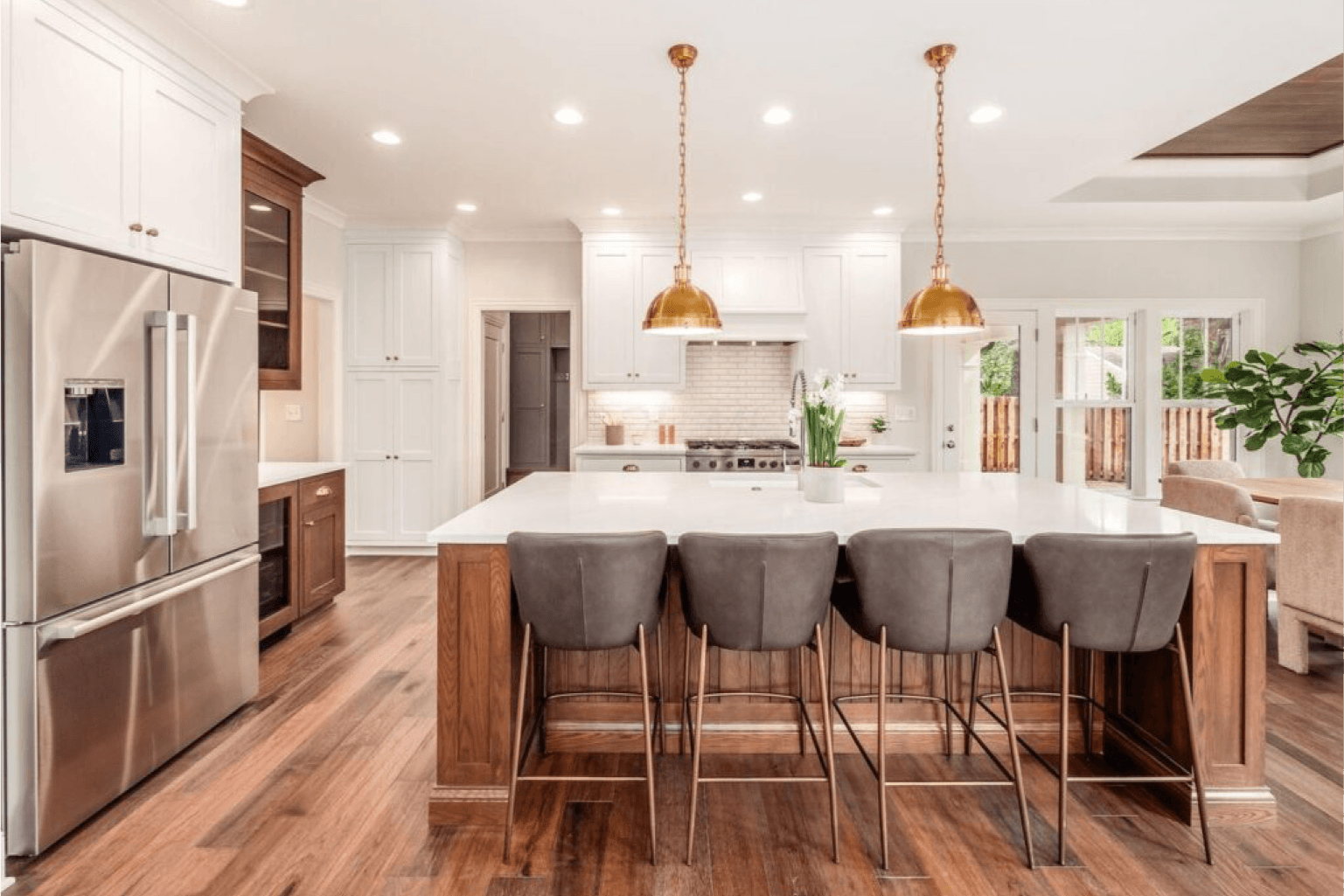 beautiful kitchen with island, barstools and light fixtures