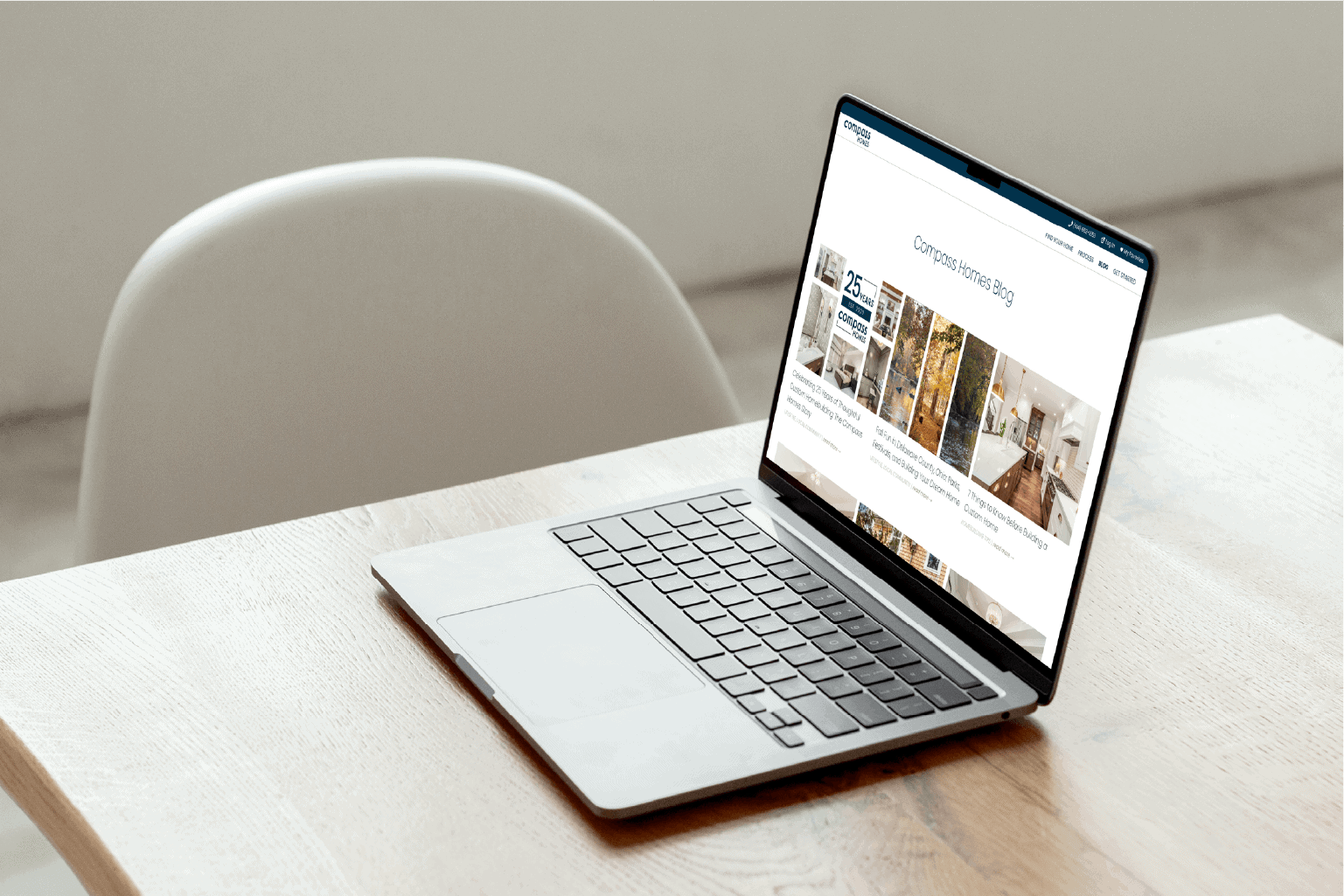 An open laptop sitting on a table with the Compass Homes blog on the screen.