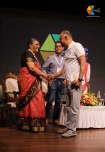 Officials exchanging handshake at India Food Safety Conclave event.