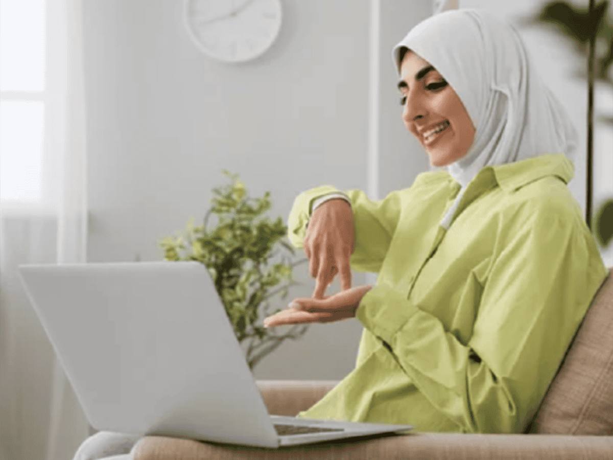 Woman smiling while using laptop