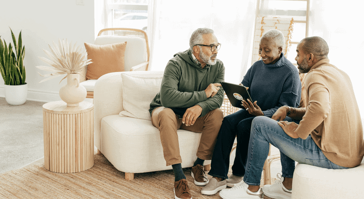 Comfortable elderly couple consulting with a real estate agent in a modern living room.