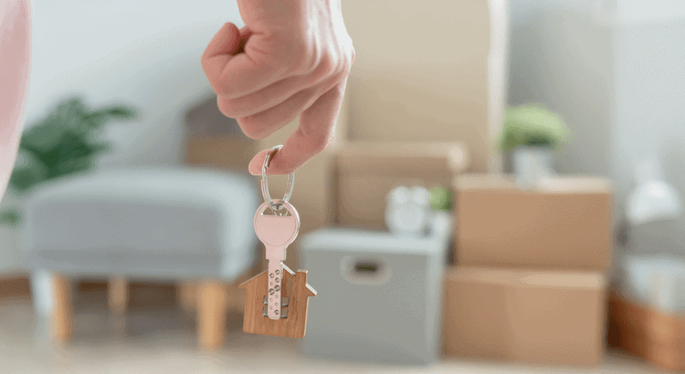 Affordable Walnut Creek real estate team holding house keys in a cozy home setting.